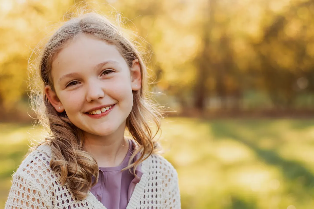 Smiling girl in warm fall light at Mingo Creek Park