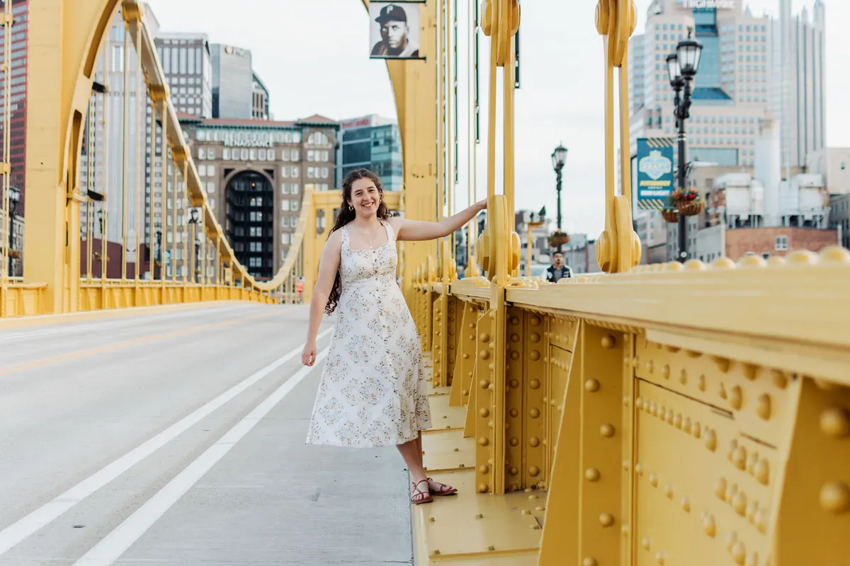 Senior walking along the Roberto Clemente Bridge toward downtown Pittsburgh