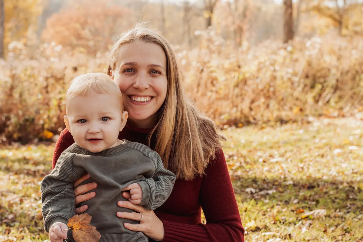 Mom holding her baby in fall light at South Park